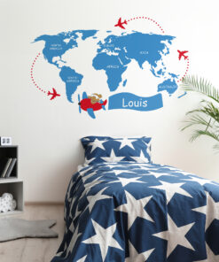Blue world map mural with red airplanes circling the globe in a child’s bedroom; blue star-pattern bedding.