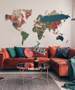 Living room with an orange sofa, colorful cushions, and a world map wall mural made from flags above the sofa.