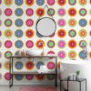 | Casadart | Vinis Autocolantes, Papel de Parede e Painéis Decorativos Modern bathroom featuring bright, circular mandala-patterned wall tiles, a white vessel sink on a metal shelf, and chrome fixtures with a pink rug on the floor.