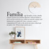 Definição-de-Familia | Casadart | Vinis Autocolantes, Papel de Parede e Painéis Decorativos Decorative wall art in Portuguese with the word 'Familia' and a family definition, above a wooden shelf with a plant and framed art under a round clock on a white wall.