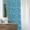 | Casadart | Vinis Autocolantes, Papel de Parede e Painéis Decorativos Corner of a bathroom with a blue teal mosaic tiled wall, a tall cactus in a white pot on a marble countertop, and dark wood vanity drawers below.