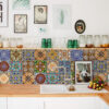 pexels-sirli-jung-9684571 copy | Casadart | Vinis Autocolantes, Papel de Parede e Painéis Decorativos Colorful tiled backsplash above a wooden counter with jars, glassware, and a white sink.