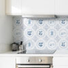| Casadart | Vinis Autocolantes, Papel de Parede e Painéis Decorativos White kitchen with stainless steel oven and stovetop beneath decorative blue Delftware tiles on the backsplash.