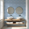 01 | Casadart | Vinis Autocolantes, Papel de Parede e Painéis Decorativos Symmetrical bathroom vanity with two round mirrors above white vessel sinks on a wooden shelf, blue geometric tiled wall.