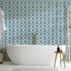 | Casadart | Vinis Autocolantes, Papel de Parede e Painéis Decorativos White freestanding bathtub in a bathroom with blue geometric diamond-pattern wallpaper; robe hangs on the left.