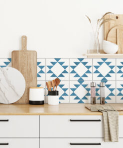 | Casadart | Vinis Autocolantes, Papel de Parede e Painéis Decorativos Kitchen counter with wooden cutting boards, a marble round board, and utensils against a blue geometric tile backsplash.