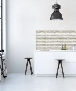 Industrial kitchen corner with white cabinets, brick backsplash, a black pendant light, stools, and a bicycle by a window on the left.
