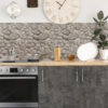 StylishInteriorOfModernKitchen | Casadart | Vinis Autocolantes, Papel de Parede e Painéis Decorativos Modern kitchen counter with stovetop, oven, dark cabinets, pebble backsplash, dish rack, and a plant on the right.