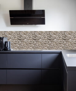 Modern black wall-mounted range hood above a dark kitchen counter with a stone-patterned backsplash below a light wall.