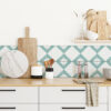kitchen interior in farmhouse style wooden countertop with kitchen utencils stove 3d rendering | Casadart | Vinis Autocolantes, Papel de Parede e Painéis Decorativos Kitchen counter with stacked wooden cutting boards, a marble round board, utensils in a black-and-white holder, white cups, and a glass vase with dried grasses against a teal diamond tile backsplash.