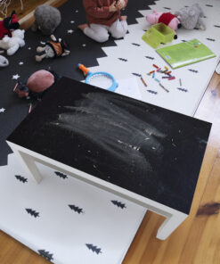 Play area for children with stuffed animals, crayons, a drawing, and a green toy bin on a star-pattern rug.