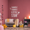 twin-pink-wall | Casadart | Vinis Autocolantes, Papel de Parede e Painéis Decorativos Nursery scene with a white crib against a pink wall and a large 'Twinkle Twinkle Little Star' wall decoration.
