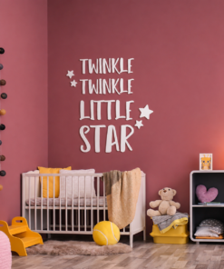 Nursery scene with a white crib against a pink wall and a large 'Twinkle Twinkle Little Star' wall decoration.