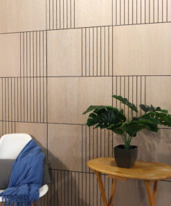 White modern chair with a blue throw draped over it, beside a small round wooden table with a potted plant against a wood-paneled wall