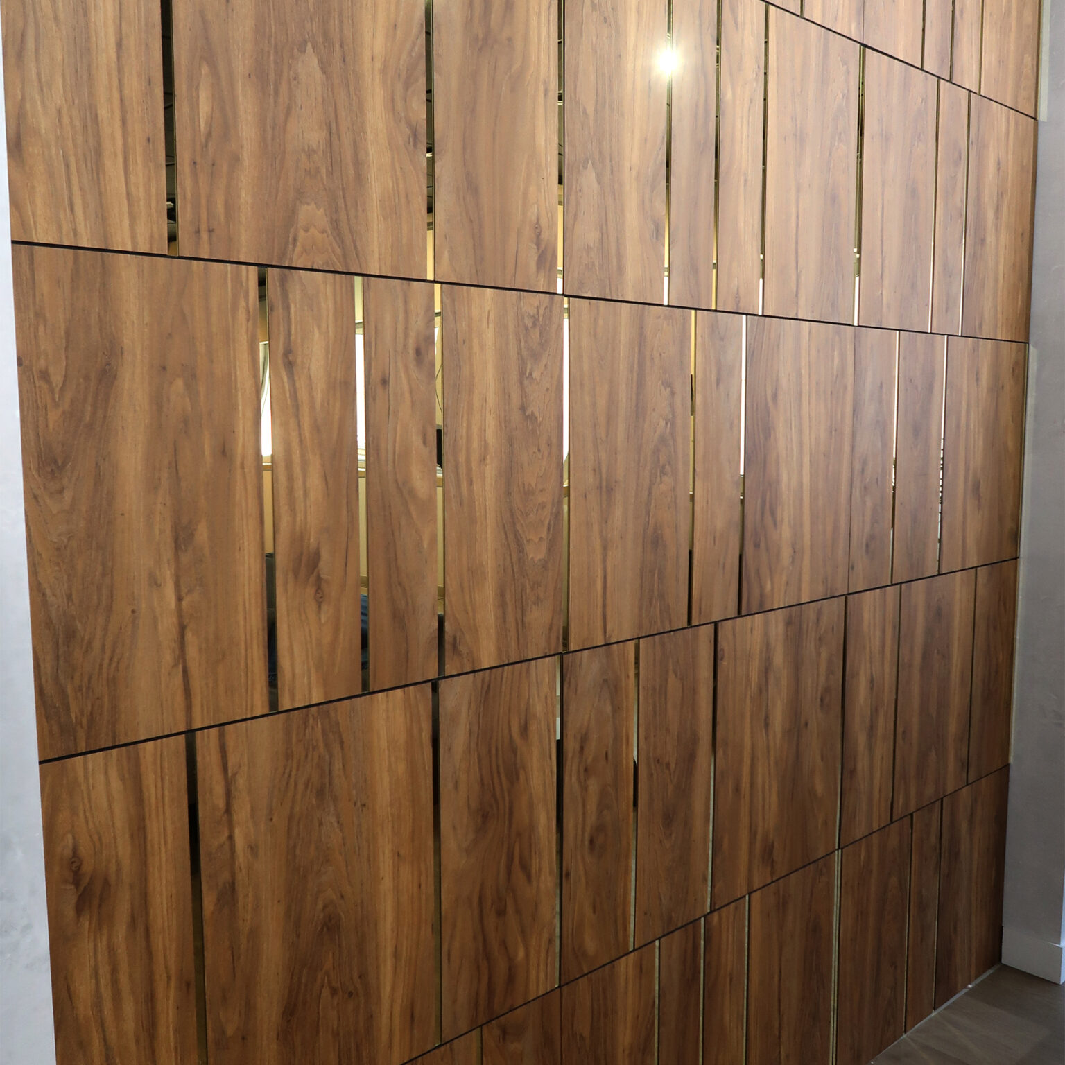 Wooden vertical slat wall panels with slim gaps and light reflections in an interior space