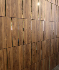 Wooden vertical slat wall panels with slim gaps and light reflections in an interior space