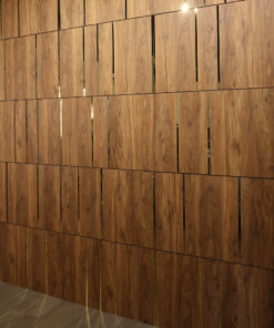 Wooden wall panels with vertical slats in a warm brown finish, corner of gray walls and light floor visible.
