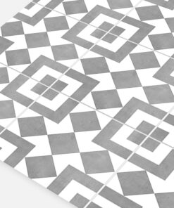 Decorative grayscale geometric tile floor with interlocking diamond and square shapes.