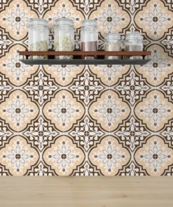 Wood shelf with five glass spice jars mounted on a decorative brown, beige, and white tiled backsplash.