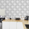 | Casadart | Vinis Autocolantes, Papel de Parede e Painéis Decorativos Kitchen counter with white cabinets, wooden worktop, and geometric black-and-white tiled backsplash in a modern kitchen setting