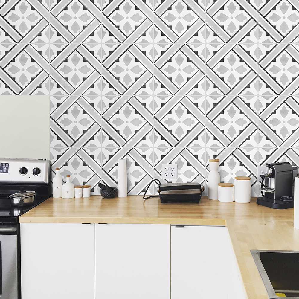 | Casadart | Vinis Autocolantes, Papel de Parede e Painéis Decorativos Kitchen counter with white cabinets, wooden worktop, and geometric black-and-white tiled backsplash in a modern kitchen setting