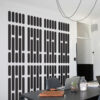 | Casadart | Vinis Autocolantes, Papel de Parede e Painéis Decorativos Modern conference room with a wall featuring vertical black rounded-rectangle pattern; table holds a laptop, notebook, water bottle, and glass.