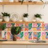 | Casadart | Vinis Autocolantes, Papel de Parede e Painéis Decorativos Wooden shelf with white bowls and glass jars, flanked by green potted plants above a wooden counter in a bright kitchen.