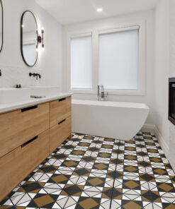 Modern bathroom with a wooden double vanity, white sinks, oval mirrors, and black fixtures against a geometric tile floor.