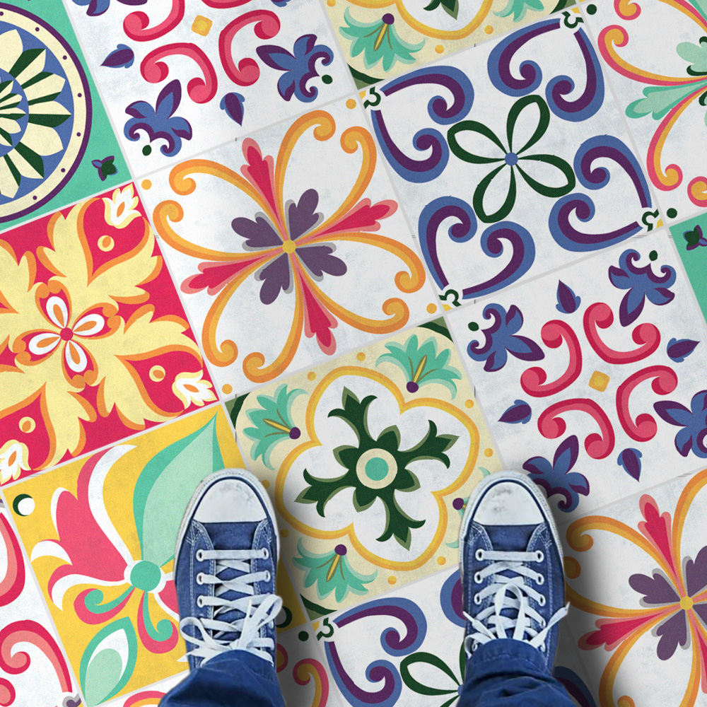 2Seville-Tile-Stickers-Floor | Casadart | Vinis Autocolantes, Papel de Parede e Painéis Decorativos Top-down view of colorful ceramic tiles with intricate floral patterns; blue sneakers visible at the bottom edge.