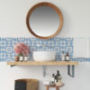 | Casadart | Vinis Autocolantes, Papel de Parede e Painéis Decorativos Round wooden-framed mirror above a white vessel sink, with a blue geometric tile backsplash and pink peonies on the counter edge.