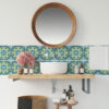 | Casadart | Vinis Autocolantes, Papel de Parede e Painéis Decorativos Round wooden-framed mirror above a white vessel sink with a turquoise patterned tile backsplash and bathroom counter items like bottles and brushes.