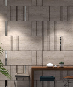 Modern dining area featuring a beige textured tiled wall, a wooden table with white ceramic bowls, and a few plants in view.