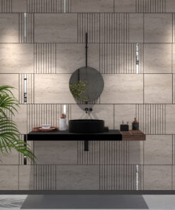 Modern bathroom vanity with round wall-mounted mirror, black vessel sink, and beige tiled wall; plant on left.