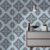 | Casadart | Vinis Autocolantes, Papel de Parede e Painéis Decorativos Interior scene with a blue-gray geometric tiled wall behind a wooden two-drawer sideboard, a small glass display, a potted plant, and a hanging pendant light above.