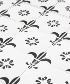 White tiled floor with a repeating black floral/scroll motif and light grout lines forming a diagonal grid.