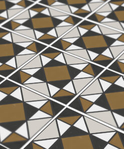 Close-up of geometric tile floor with white, black, and gold triangles forming diamonds.