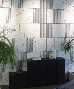 Marble-pattern wall with vertical black line motifs, a dark storage cabinet, and green ferns framing the scene with decorative vases and books on top of the cabinet.