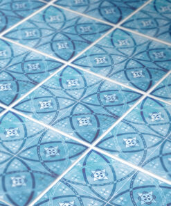 Decorative blue tile pattern with overlapping circles and a small star-like emblem in each tile.