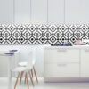 ds kitchen black -1 copy 5 | Casadart | Vinis Autocolantes, Papel de Parede e Painéis Decorativos Modern kitchen with a black-and-white geometric tile backsplash, white cabinets, and a white dining table with white chairs and wooden legs.