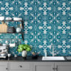 | Casadart | Vinis Autocolantes, Papel de Parede e Painéis Decorativos Kitchen with teal patterned tile backsplash, gray cabinets, a toaster and kettle, stacked dishes, and a green potted plant.