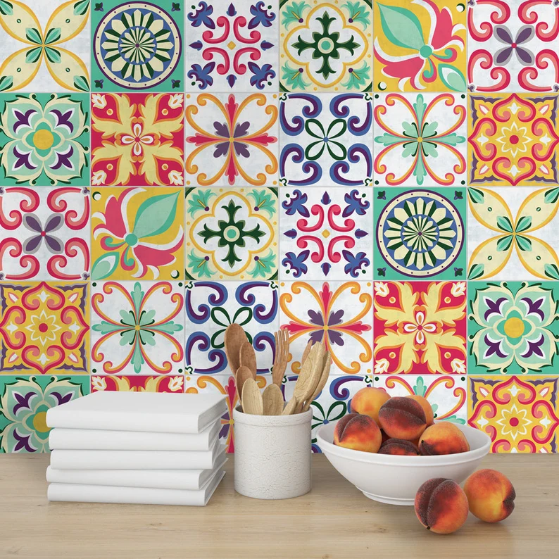 | Casadart | Vinis Autocolantes, Papel de Parede e Painéis Decorativos Colorful tile-patterned wall over a wooden countertop with a stack of white books, a utensil holder with wooden spoons, and a bowl of peaches.
