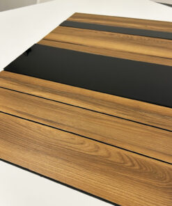 Wood veneer sample panels laid in parallel with black spacer strips on a white surface, showing wood grain and color variations.