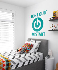 Teal wall decal reading 'I DON'T QUIT I RESTART' with a power button icon in a bright kid's bedroom.