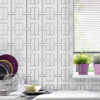 | Casadart | Vinis Autocolantes, Papel de Parede e Painéis Decorativos White kitchen wall with a bold black geometric tile pattern, stacked dishes on a rack to the left, and a window with blinds on the right.