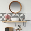 | Casadart | Vinis Autocolantes, Papel de Parede e Painéis Decorativos Round wooden-framed mirror above a bathroom sink with gray geometric tiles and pink flowers nearby in the scene.