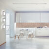 | Casadart | Vinis Autocolantes, Papel de Parede e Painéis Decorativos Bright modern kitchen and dining area with white cabinets, terrazzo backsplash, and white dining table with wooden legs.