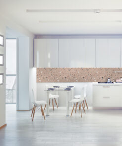 Bright modern kitchen and dining area with white cabinets, terrazzo backsplash, and white dining table with wooden legs.