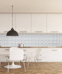 Modern kitchen with white cabinets, a black pendant lamp, and a patterned tile backsplash over a wooden floor.